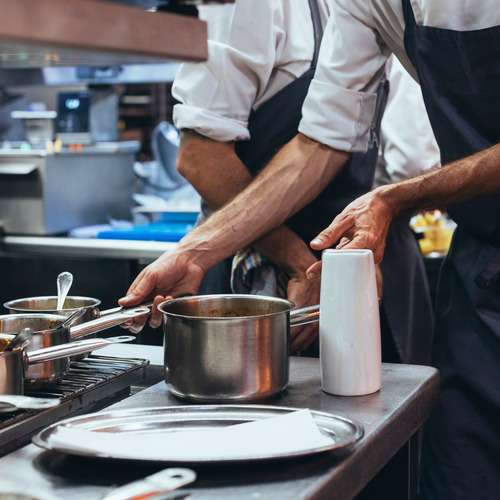 Kitchen staff preparing a meal, highlighting rewarding restaurant careers at La Marsa